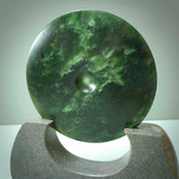 Hand carved New Zealand Marsden Jade Disc with Greywacke stand sculpture. Hand carved here in New Zealand by Ric Moor. This is a 'one only' sculpture, a beautiful display piece.